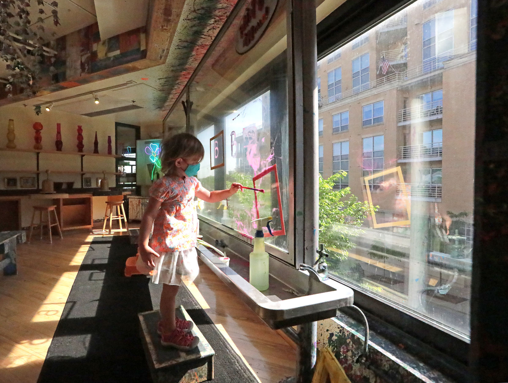 Child painting on glass at Madison Children's Museum